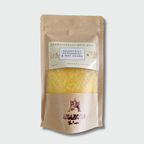 Aromatherapy bath salt package with yellow bath salt on a light gray background