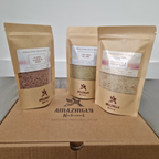 Three packages of Himalayan bath salt from Amazingly Natural on a gift box.